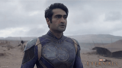A Poster For The Movie Eternals Shows A Man In A Purple Armor GIF