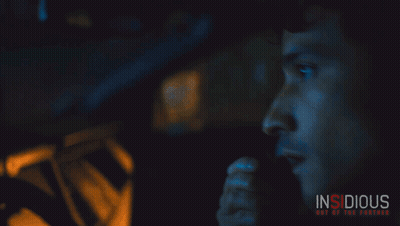A Poster For The Movie Insidious Shows A Man Talking On A Phone GIF