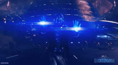 A Poster For The Movie Quantumania Shows A Person Holding A Beam Of Light GIF