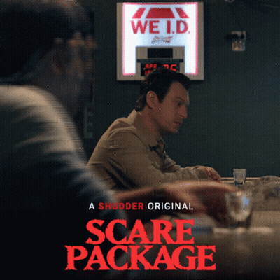 A Poster For The Movie Scare Package Shows Two Men Sitting At A Bar GIF