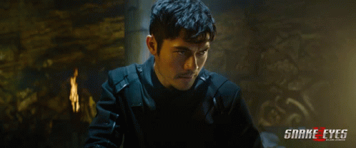 A Poster For The Movie Snake Eyes Shows A Man In A Black Jacket GIF