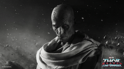 A Poster For The Movie Thor Lone Thunder Shows A Bald Man With Red Eyes GIF