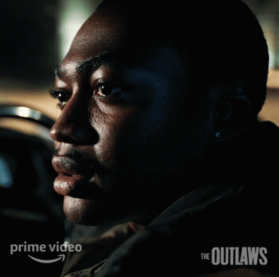 A Poster For The Outlaws Shows A Man Sitting In A Car GIF