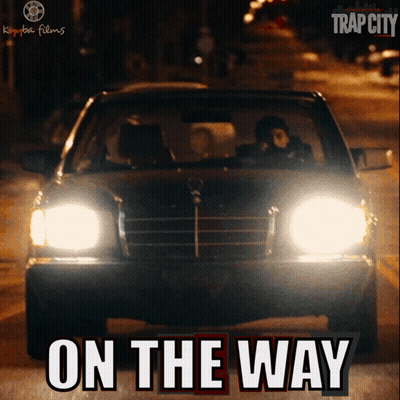 A Poster For Trap City Shows A Car Driving Down The Street GIF