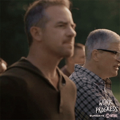 A Poster For Work Progress Shows A Man Clapping GIF