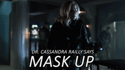 A Poster Of A Woman Wearing A Gas Mask With The Words " Dr. Cassandra Railly Says Mask Up " GIF