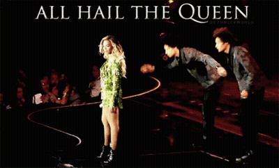 A Poster That Says All Hail The Queen With A Woman In A Green Dress GIF