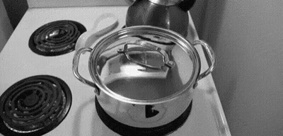 A Pot Is Sitting On Top Of A Stove With The Lid Open . GIF