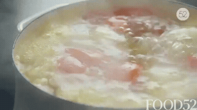 A Pot Of Soup Is Being Cooked On A Stove With The Words Food52 On The Bottom . GIF