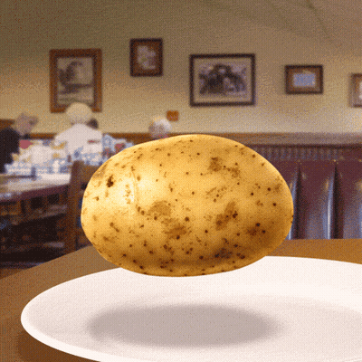 A Potato Is Floating On A White Plate GIF