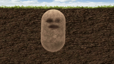 A Potato With A Face On It Is Buried In The Ground GIF
