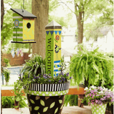 A Potted Plant With A Welcome Sign Hanging From It GIF