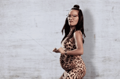 A Pregnant Woman In A Leopard Print Dress GIF
