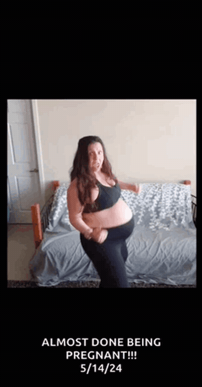 A Pregnant Woman Is Dancing On A Bed With The Words `` Almost Done Being Pregnant '' Written On The Bottom . GIF