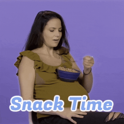 A Pregnant Woman Is Eating A Bowl Of Cereal With The Words Snack Time Written On The Bottom GIF