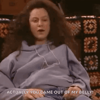 A Pregnant Woman Is Sitting On A Couch With Headphones On And Says `` Actually You Came Out Of My Belly ! '' GIF