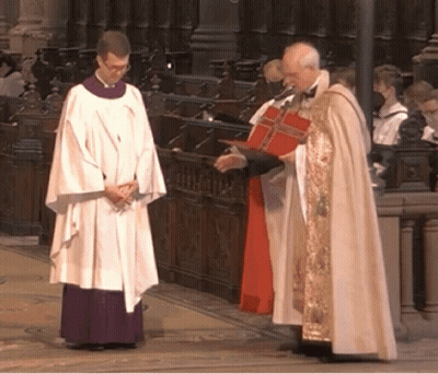 A Priest In A White Robe Is Talking To Another Priest GIF