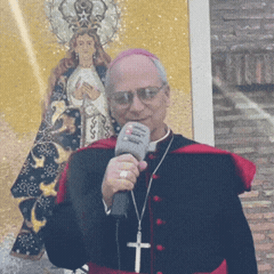 A Priest Is Holding A Microphone In Front Of A Painting GIF