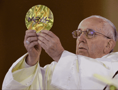A Priest Is Holding A Piece Of Paper That Says ' Megas ' On It GIF