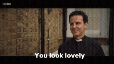 A Priest Is Standing In Front Of A Brick Wall And Smiling While Saying `` You Look Lovely '' . GIF