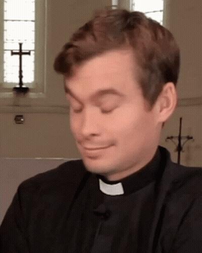 A Priest Making A Funny Face With His Eyes Closed In Front Of A Cross GIF