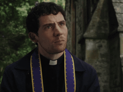A Priest Wearing A Purple And Yellow Stole With A Cross On It GIF