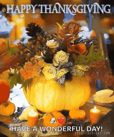 A Pumpkin Filled With Flowers And Candles Is On A Table With A Happy Thanksgiving Message . GIF