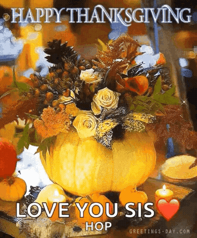A Pumpkin Filled With Flowers And Candles On A Table . GIF