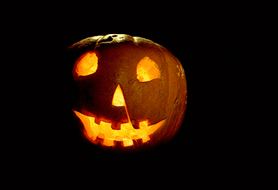 A Pumpkin With A Face Carved Into It Is Lit Up GIF