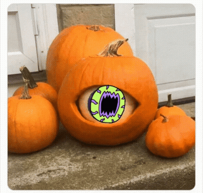 A Pumpkin With A Green Eye And Mouth Is Surrounded By Smaller Pumpkins . GIF