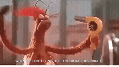 A Puppet Is Holding A Hair Dryer In Its Hand . GIF