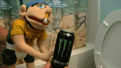A Puppet Is Holding A Monster Energy Drink In Front Of A Toilet GIF
