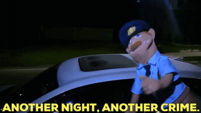 A Puppet Police Officer Standing Next To A Police Car With The Words Another Night Another Crime GIF