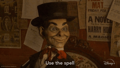 A Puppet Says Use The Spell In Front Of A Wall With Posters GIF
