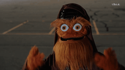 A Puppet With A Beard And Big Eyes Is Wearing A Helmet GIF