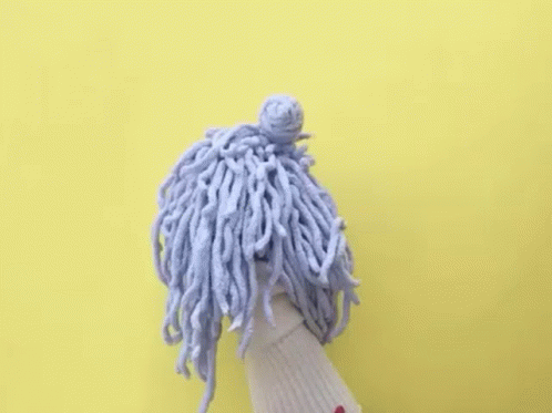 A Puppet With A Mop On Its Head And The Words `` Baller Time '' Written Above It . GIF