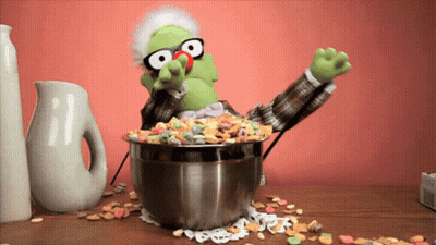 A Puppet With Glasses And A Bowl Of Cereal GIF