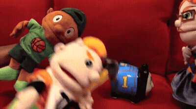 A Puppet With The Number 1 On It Is Being Held By Another Puppet GIF