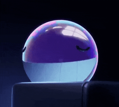 a purple and blue ball with a face on it is sitting on a table .