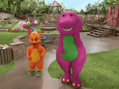 A Purple And Orange Dinosaur Standing Next To Each Other On A Sidewalk GIF