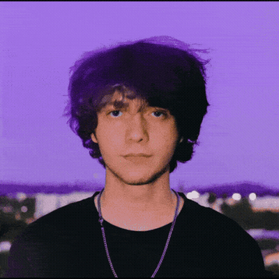 A Purple Background With A Man Wearing Glasses GIF