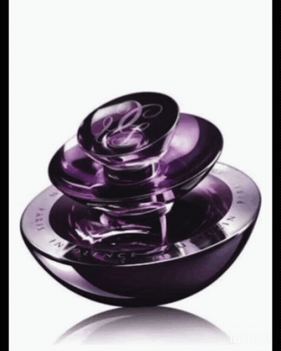 A Purple Bottle Of Perfume With The Word Paris On The Front GIF