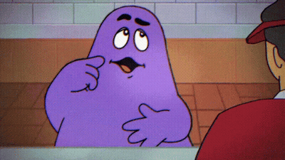 A Purple Cartoon Character Is Talking To A Man GIF