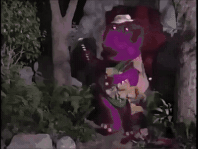 A Purple Dinosaur Is Standing In A Forest Wearing A Hat . GIF