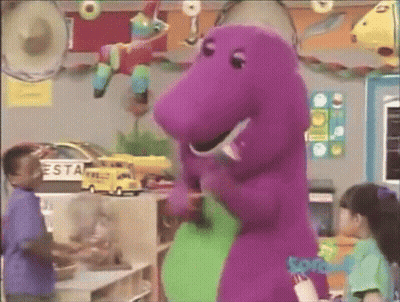 A Purple Dinosaur Is Standing Next To A Green Dinosaur In A Room With Children . GIF