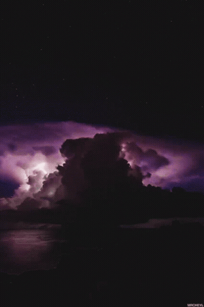 A Purple Lightning Storm Over A Body Of Water With Micheyl At The Bottom GIF