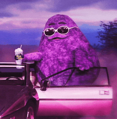 A Purple Mcdonald 'S Character Sitting In A Car GIF