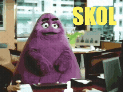 A Purple Mcdonald 'S Mascot Is Standing In Front Of A Desk With The Word Skol In Yellow Letters GIF