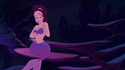 A Purple Mermaid Is Sitting On A Rock In A Dark Cave GIF