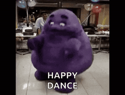 A Purple Monster Is Dancing In A Room With The Words Happy Dance Below It GIF
